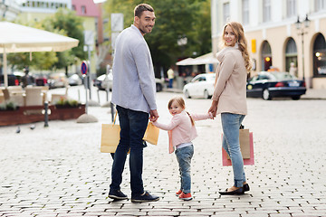 Image showing happy family with child and shopping bags in city