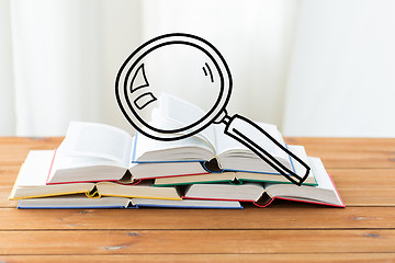 Image showing close up of books on table with loupe doodle