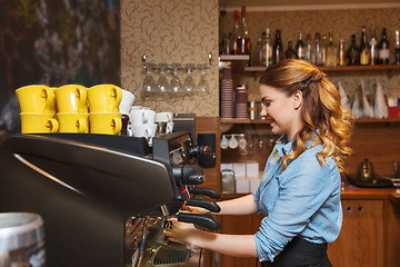 Image showing barista woman making coffee by machine at cafe