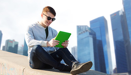 Image showing happy young man with tablet pc in city
