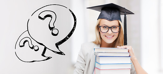 Image showing happy student woman in mortarboard with books