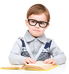 Image showing Little child play with book