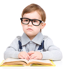 Image showing Little child play with book