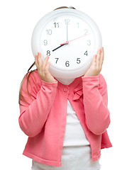 Image showing Little girl is holding big clock