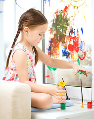 Image showing Portrait of a cute girl playing with paints