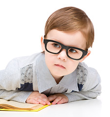 Image showing Little child play with book