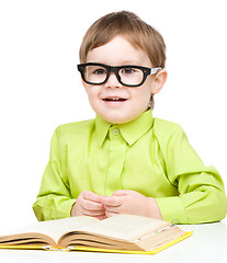 Image showing Little child play with book