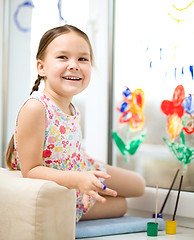 Image showing Portrait of a cute girl playing with paints