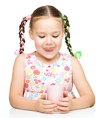 Image showing Cute little girl with a glass of milk