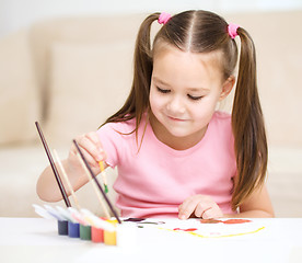 Image showing Cute cheerful child play with paints