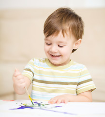 Image showing Little boy is playing with paints