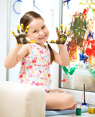 Image showing Portrait of a cute girl playing with paints