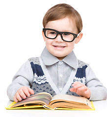 Image showing Little child play with book