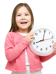 Image showing Little girl is holding big clock