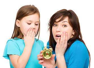 Image showing Little girl and her mother are anxious about time