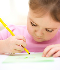 Image showing Cute cheerful child drawing using felt-tip pen