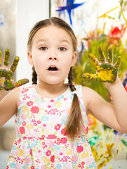 Image showing Portrait of a cute girl playing with paints