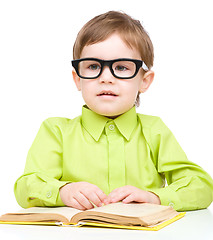 Image showing Little child play with book