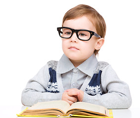 Image showing Little child play with book