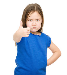 Image showing Little girl is showing thumb up gesture