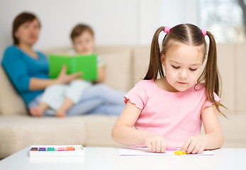 Image showing Little girl is playing with plasticine