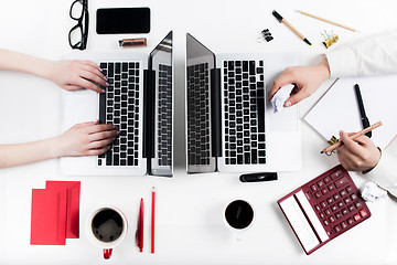 Image showing The female  and male hands on the workplace