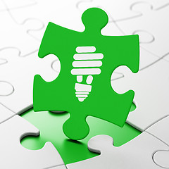 Image showing Business concept: Energy Saving Lamp on puzzle background