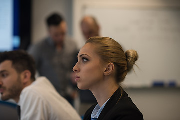 Image showing portrait of young business woman at office with team on meeting 