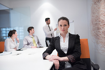 Image showing young business woman on meeting  using laptop computer