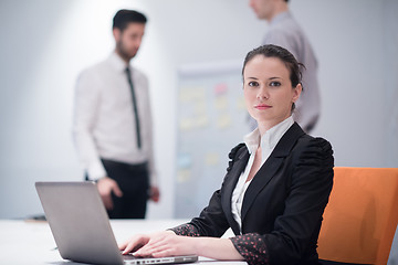 Image showing young business woman on meeting  using laptop computer