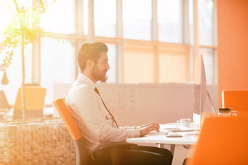 Image showing relaxed young businessman first at workplace at early morning