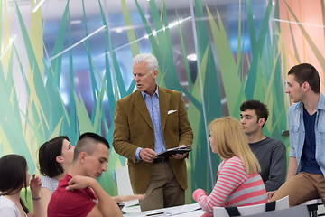 Image showing teacher with a group of students in classroom