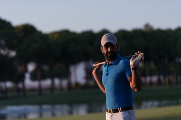 Image showing golfer  portrait at golf course on sunset