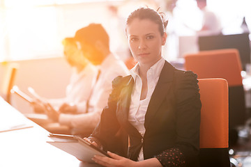 Image showing business woman at  office people group on meeting  in background