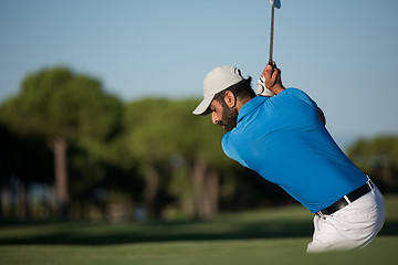 Image showing pro golfer hitting a sand bunker shot