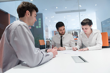 Image showing young couple signing contract documents on partners back