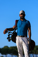 Image showing golfer  portrait at golf course on sunset