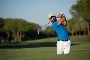 Image showing pro golfer hitting a sand bunker shot