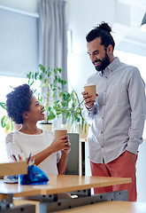 Image showing happy man and woman drinking coffee in office