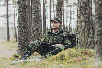 Image showing young soldier or hunter with gun in forest