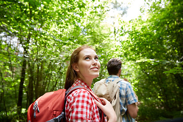 Image showing group of smiling friends with backpacks hiking