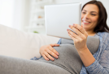 Image showing close up of pregnant woman with tablet pc at home