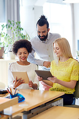 Image showing happy creative team with tablet pc in office