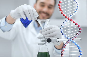 Image showing close up of scientist with test tubes and funnel