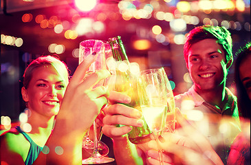 Image showing smiling friends with wine glasses and beer in club
