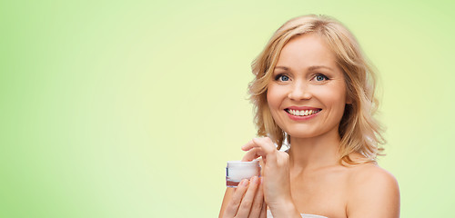 Image showing happy woman with cream jar