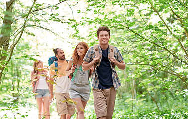 Image showing group of smiling friends with backpacks hiking