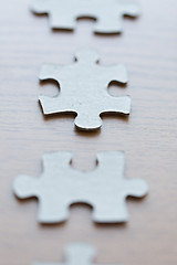 Image showing close up of puzzle pieces on wooden surface