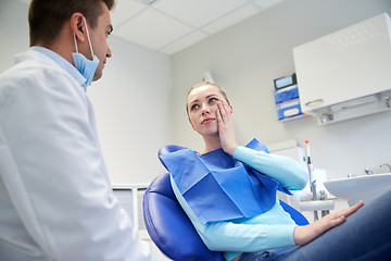 Image showing male dentist with woman patient at clinic