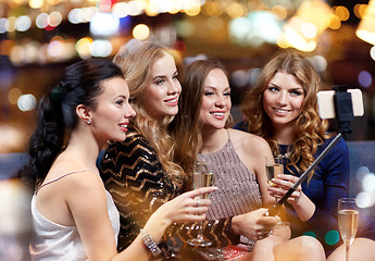 Image showing women with smartphone taking selfie at night club